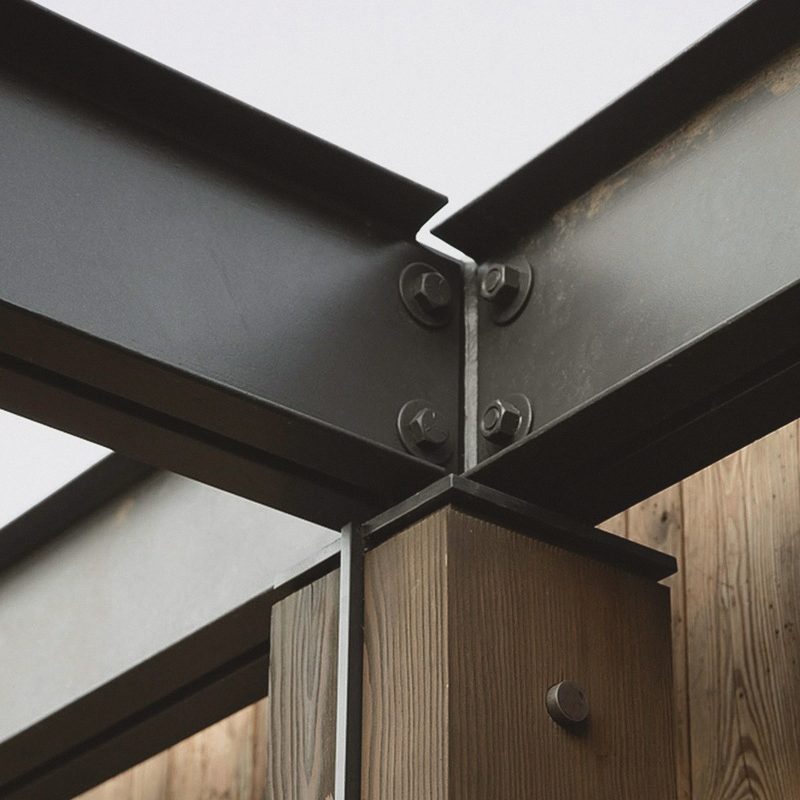 A steel beam connection above a timber column