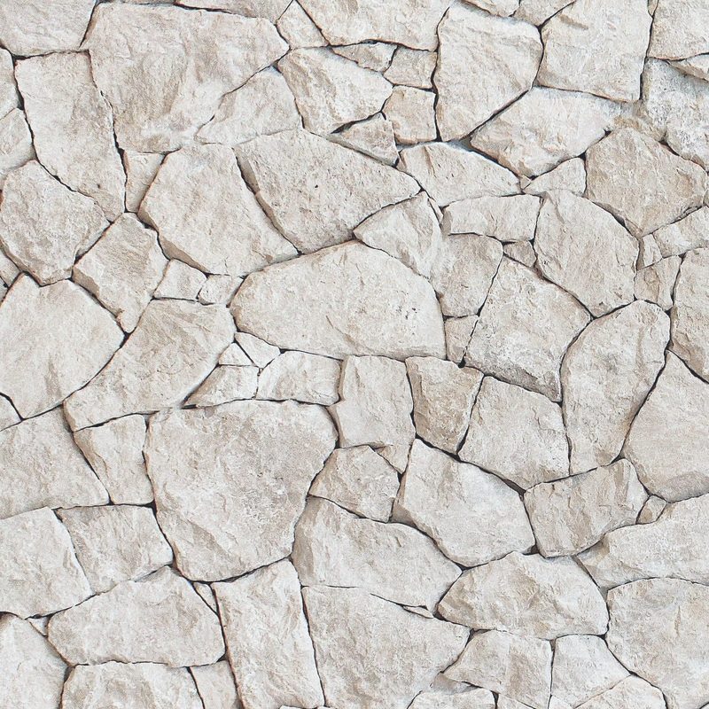 A wall of pale natural stone