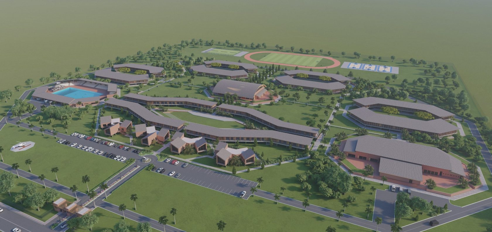 The full campus from the air: curving teaching blocks around a central green, boarding houses, pool, sports hall and track, with the entrance from the coastal highway